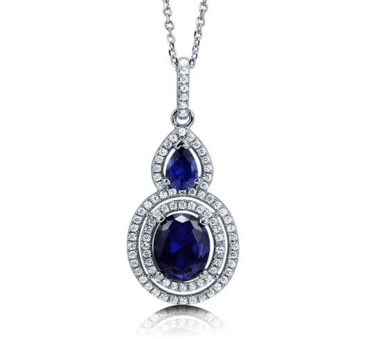 Halo Simulated Blue Sapphire Oval CZ Necklace in Sterling Silver